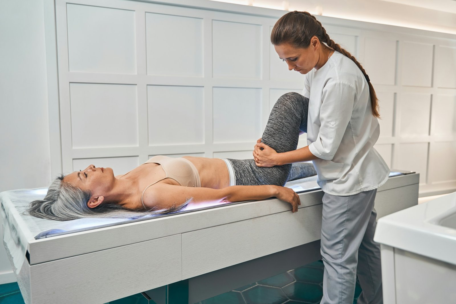 Professional medical worker giving therapy treatment to patient